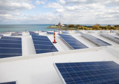 Solar panels on the roof of the Shedd Aquarium in Chicago and view of Lake Michigan